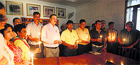 Police officials, DAV School staff and members of the Akhil Bharatiya Human Rights Organisation light candles to pray for the victims of Malaysian Airline flight MH 17 in Amritsar on Friday.