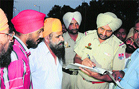 Policemen investigate at the spot where a bus ran over a migrant who alighted from the bus on Friday evening in Amritsar.