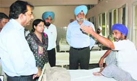 Divisonal Commissioner VK Sharma interacts with a drug addict during an ispection at the de-addiction centre in Bathinda on Friday.