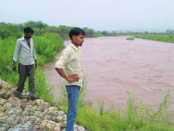 Farmers watch the rising water level of the Ghaggar near Chhat Bir Zoo on Friday.
