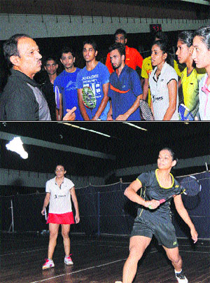 Senior badminton coach Surinder Mahajan gives tips to upcoming badminton players from across the country during a camp at the PU; and (below) badminton players in action during a practice match at the camp in the university.
