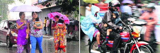 Residents enjoy monsoon showers in Dehradun on Friday. The mercury dipped sharply in the city following rain.