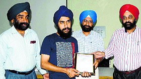 College authorities felicitate Jaswinder Singh Sodhi for his success.