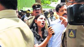 An irate parent talks to the police during a protest in Bengaluru on Friday.