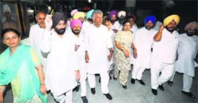 Congress legislators led by CLP Leader Sunil Jakhar walk out of the Assembly on Friday.