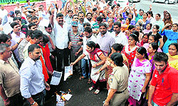 Members of various Hindu organisations burn the posters of the play, Dharamraj.com, outside the Tagore Theatre, Sector 18, Chandigarh, on Saturday