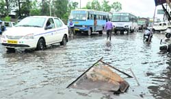 A street inundated with water after heavy rain at the ISBT in Dehradun on Saturday. A Tribune photograph