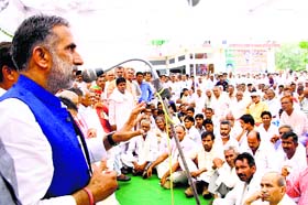 Making a point: Union Minister of State for Road Transport Krishan Pal Singh Gurjar addresses a public meeting in Mahendragarh on Saturday
