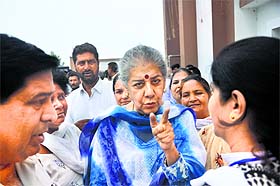 All India Congress Committee general secretary and in charge of J&K affairs Ambika Soni talks to party activists before attending a convention in Jammu