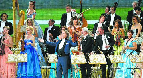 Dutch violinist Andre Rieu gestures during a concert of his orchestra on Vrijthof square, in Maastricht, southern Netherlands. Rieu celebrated the 10th anniversary of his traditional summer evening concerts in his hometown.