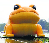 A giant inflatable toad is seen floating on a lake at the Yuyuantan Park in Beijing on Saturday. The golden toad, which represents wealth and good fortune in traditional Chinese culture, is 72.2-foot tall.