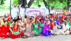 Members of the ASHA Facilitator Union, Punjab, raise slogans against the state government seeking wage enhancement in Amritsar on Sunday.