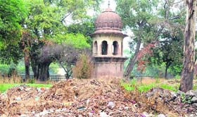 Garbage dumped near the historic watch tower at Company Bagh