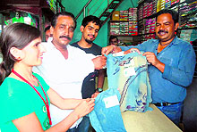 U-Turn Foundation volunteers distribute cloth bags among shoppers during an anti-polythene bag campaign in Dehradun on Sunday