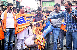 Members of the Bajrang Dal burn an effigy of Jammu and Kashmir Chief Minister Omar Abdullah at Clock Tower in Dehradun on Sunday