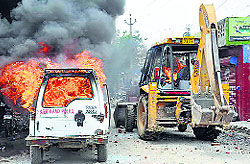 Protesters set afire a police jeep and a jcb machine in Faridabad on Sunday