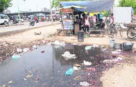 A roadside dhaba runs near garbage and filth