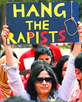 A woman protests against the rape of a girl in a public school, in Bengalore on Sunday