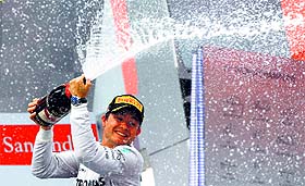 Nico Rosberg sprays champagne as he celebrates on the podium after winning the German GP in Hockenheim on Sunday. 