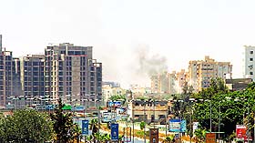 Smoke billows from the site of clashes on the road leading to the airport in the Libyan capital Tripoli on Sunday.