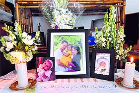 A tribute: Family pictures are displayed showing Arnold Huizen (L), his wife Yodricunda (R) and their daughter Yelena at Indonesias resort island of Bali on Sunday.