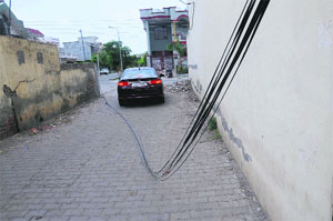 A bunch of telephone wires lying unattended on the ground near Tagore Nagar in Bathinda on Monday.