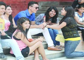 Freshers share lighter moments during the first day of the new academic session of Delhi University at Miranda College, North Campus on Monday