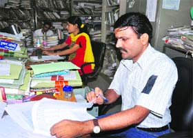 Secretariat workers protest by putting black bands on their arms in Dehradun on Monday