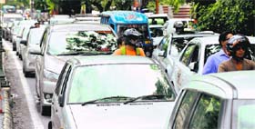 Vehicles move at a snails pace on the east canal road in Dehradun on Monday