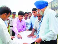 Jind DC Rajiv Rattan with the university officials during an inspection on Sunday. A Tribune Photograph