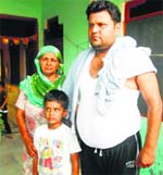 Aryan with his father, who lodged a complaint at Kharkhoda police station on Monday. A Tribune Photograph