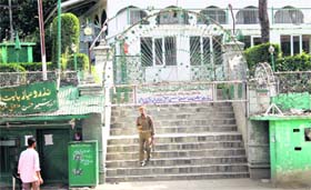 A policeman stands guard in front of the shrine of Sufi saint Syed Hassan Mantaqui after militants attempted to snatch weapons from the police at Awantipora in Pulwama district on Monday.