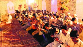 Kashmiri Muslims offer prayers after iftaar in Pulwama district on the 22nd day of Ramadan on Monday. 