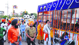 Activists of various Sikh organisations participate in Shastradhari Nagar Kirtan to mark Miri Piri Diwas; and (right) a boy performs gatka on the occasion in Jalandhar on Monday.