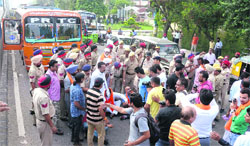 Shiv Sena activists block GT Road in Jalandhar on Monday.