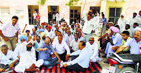 PSPCL staff protest the delay in arrest of the accused in Abohar on Monday.