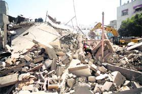 Searching for life: A Palestinian civil defence worker searches for survivors amidst the rubble of a building destroyed in an Israeli air strike, in Gaza City, on Monday