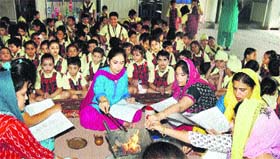 Students and teachers of DAV Public School attend a havan on Tuesday in Amritsar.