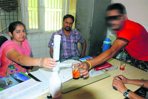A patient takes medicines from the staff at the drug de-addiciton centre in Bathinda. 