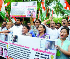 Youth Congress workers shout slogans during a demonstration against the Modi government on the issue of death of Manipuri youth at Jantar Mantar in New Delhi on Tuesday. 