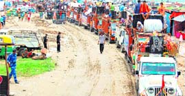 Dak Kanwariyas travelling in vehicles arrive at the Bairagi camp in Haridwar on Tuesday to fetch Ganga water.
