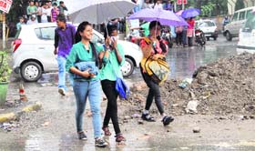 Girls enjoy heavy downpour in Dehradun on Tuesday.