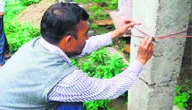 MDDA authorites seal a house at Jharipani in Mussoorie on Tuesday.