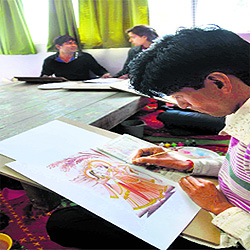 Artists give final touches to a Kangra miniature painting in Shimla.
