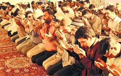 Kashmiri Muslims offer prayers after iftaar in Srinagar on the 23rd day of Ramadan on Tuesday. Tribune photo: Amin War