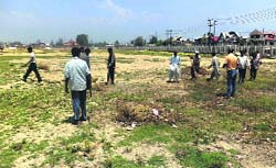 SMC workers during sanitation drive at Eidgah on Tuesday. A Tribune photograph
