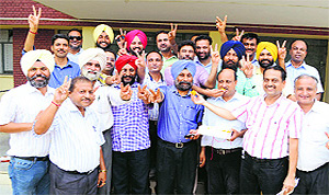 Newly elected president of Punjab Agricultural University Teachers Association Dr KS Sanga (first row, blue turban) along with members of the Kingra group in a jubilant mood after the declaration of results in Ludhiana on Tuesday