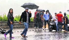 Youngsters enjoy at Futala Lake during rain in Nagpur on Tuesday.