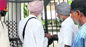 Residents lock the gate of Government Senior Secondary School at Saron village near Sangrur on Tuesday