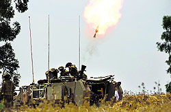 Israeli soldiers fire a mortar towards the Gaza Strip on Tuesday